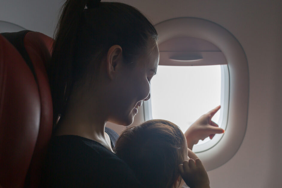 Mother pointing out during airplane ride