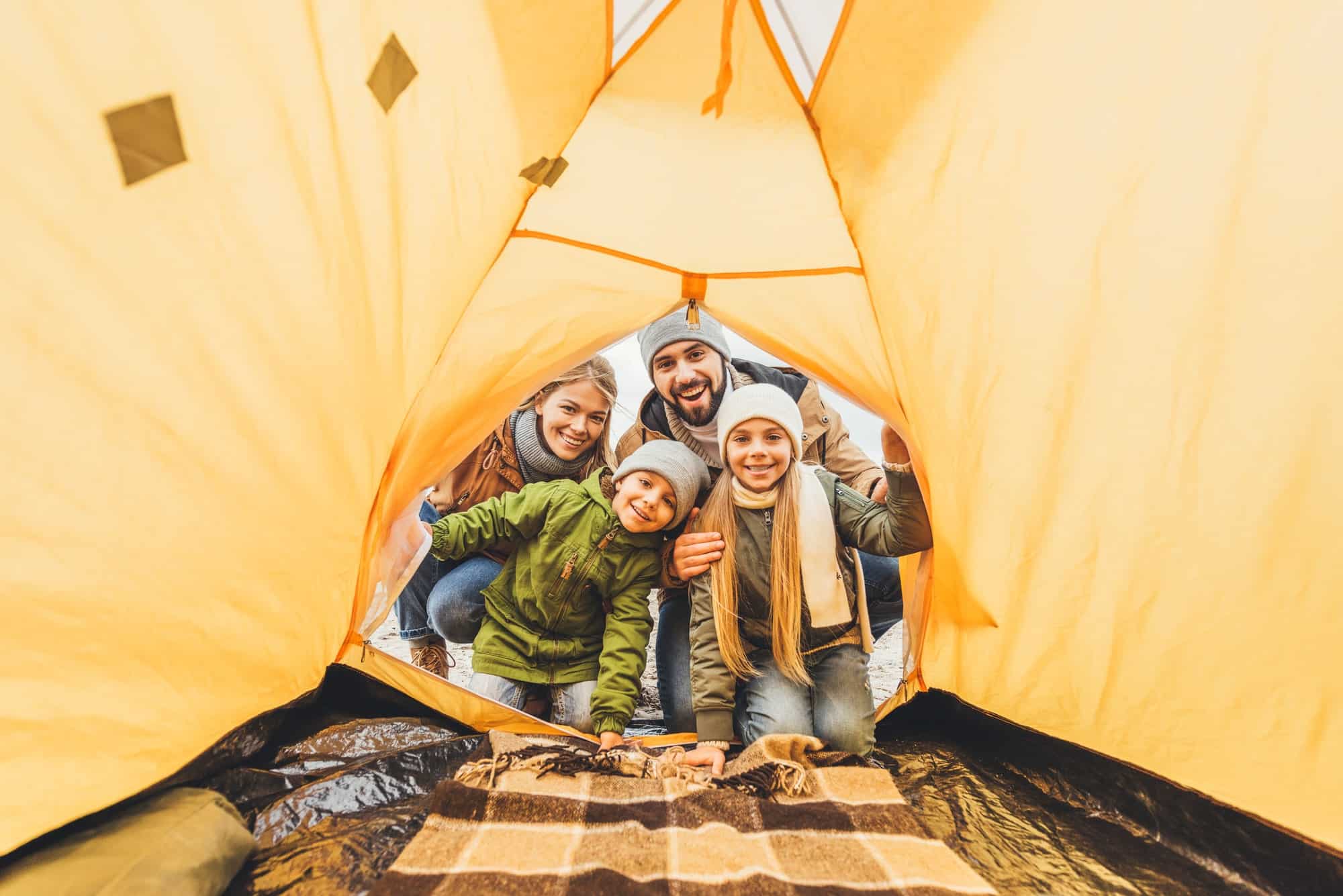 Family looking inside a tent