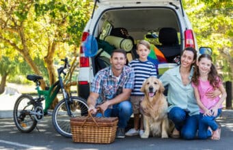 How to Survive a Road Trip With Toddlers Happy family getting ready for road trip on a sunny day