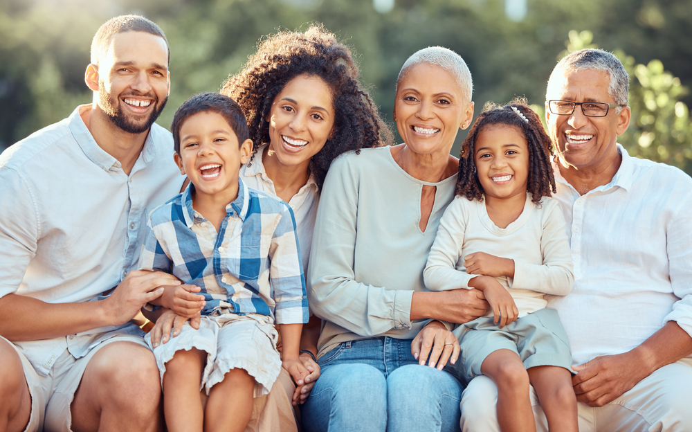 Big family portrait in a park with grandparents and children for summer, outdoor holiday and wellness. Happy grandmother, grandfather with mom, dad and kids in nature, bonding and bokeh lens flare